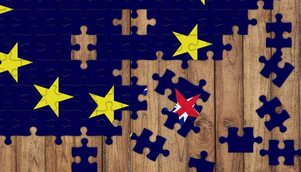 puzzle from eu flag and missing parts of british flag in star shape brexit concept on wooden background