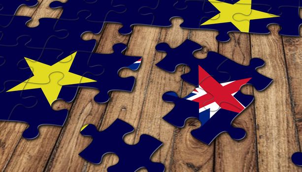 puzzle from eu flag and missing parts of british flag in star shape brexit concept on wooden background