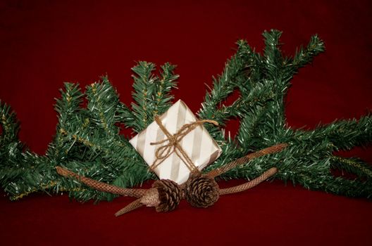 christmas decoration made from christmas tree and gift box on red background