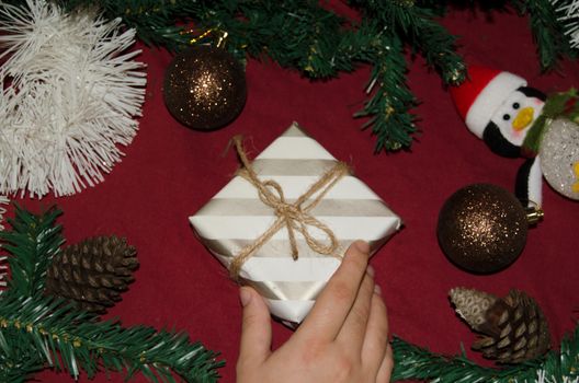 New year or Christmas flat lay top view of woman hand holding gift , red background