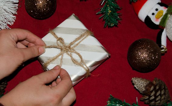 christmas decoration made from christmas tree and gift box on red background