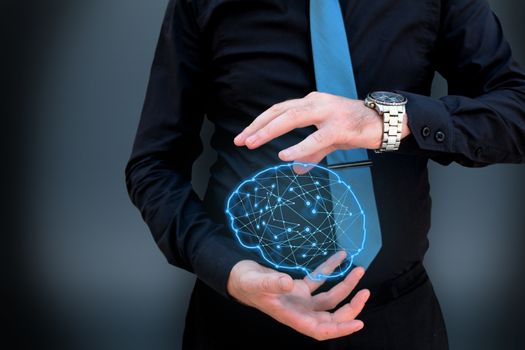 Man holding glowing polygonal brain on dark background. Artificial intelligence and mind concept