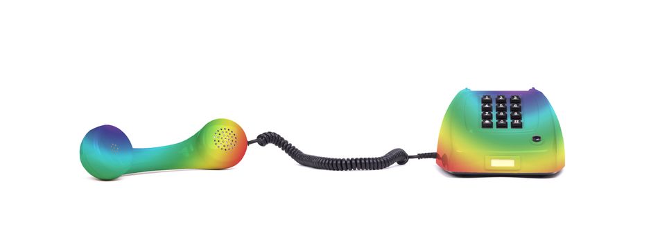 Vintage rainbow colored telephone with a white background
