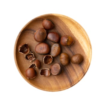 Top view chestnuts on wooden plate isolated on white background.