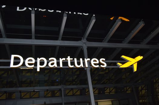 Information about the departure zone, signpost of the aircraft at the airport at night, the concept of travel.