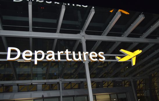 Information about the departure zone, signpost of the aircraft at the airport at night, the concept of travel.