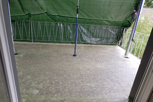 Balcony floor tiles installation. Laying tiles from porcelain. Interior remodeling theme.