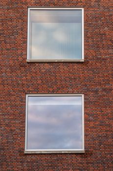 Two big windows with a Brick wall as architecture background.