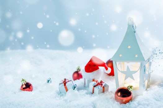 Christmas holidays card with gifts , balls , sants claus hat and glowing lantern in snow