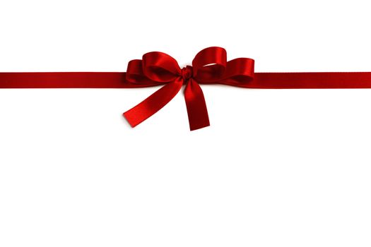 Shiny red satin ribbon and bow isolated on white background. Holiday gift concept