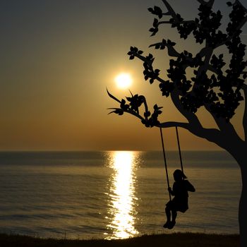 Happy child girl on swing in sunrise at the seaside