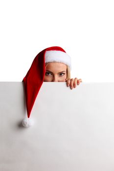 Christmas woman peeking over edge of white billboard with copy space for text