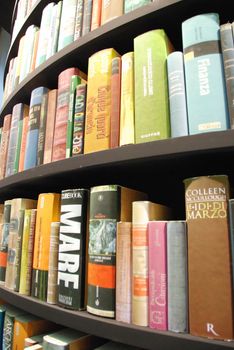 Detail of books in a tower-shaped bookcase - Turin, Italy - May 2011