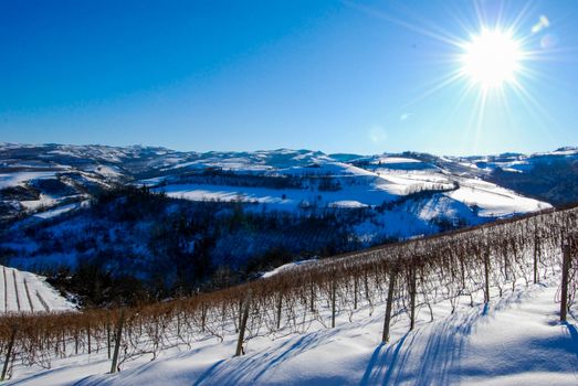 View of Langhe hills with snow, Piedmont - Italy