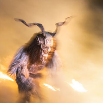 The Krampus masks in an exhibition in the night in Tarvisio, Italy