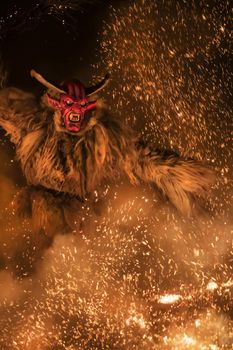 The Krampus masks in an exhibition in the night in Tarvisio, Italy