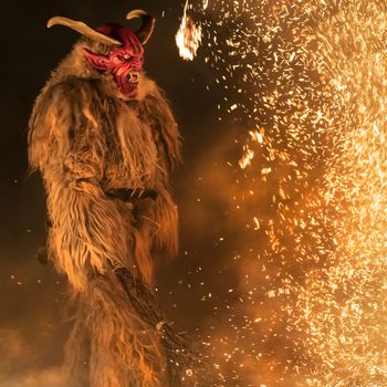 The Krampus masks in an exhibition in the night in Tarvisio, Italy