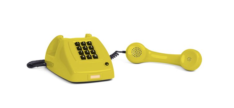 Vintage yellow telephone with a white background