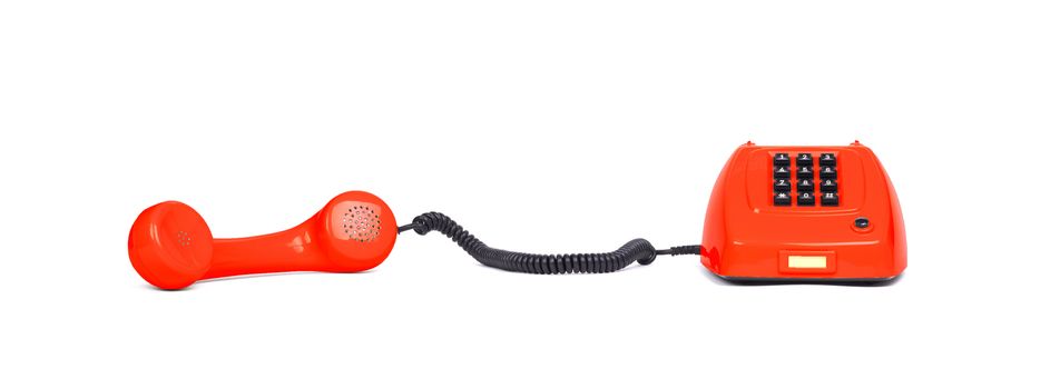 Vintage red telephone with a white background