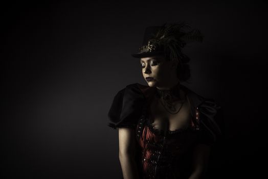 Emotional Portrait of Young Woman in Steampunk or Retro style. Studio shot. Model on a Black Background