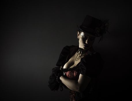 Emotional Portrait of Young Woman in Steampunk or Retro style. Studio shot. Model on a Black Background