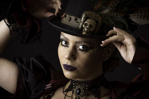 Emotional Portrait of Young Woman in Steampunk or Retro style. Studio shot. Model on a Black Background