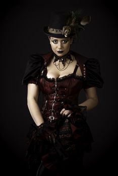 Emotional Portrait of Young Woman in Steampunk or Retro style. Studio shot. Model on a Black Background