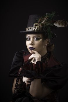 Emotional Portrait of Young Woman in Steampunk or Retro style. Studio shot. Model on a Black Background