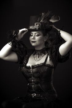 Emotional Portrait of Young Woman in Steampunk or Retro style. Studio shot. Model on a Black Background