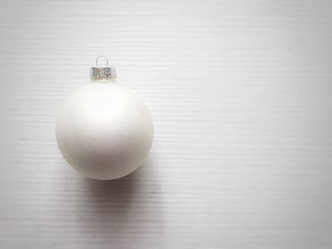 white christmas ball on a white wooden table