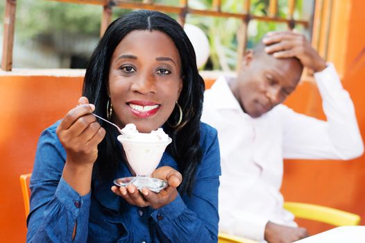 smiling young woman holding in her hand a glass of ice and looking at the camera.