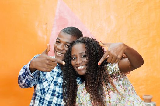This young happy couple waved fingers to show their joy.