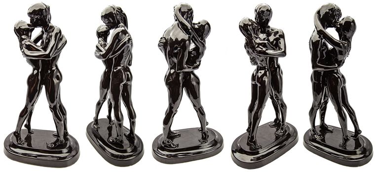 Black glossy ceramic statue of a nude couple kissing