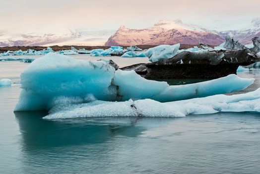 Icebergs in the Jokulsarlon's lake near Vatnajokull glacier at sunrise, Iceland