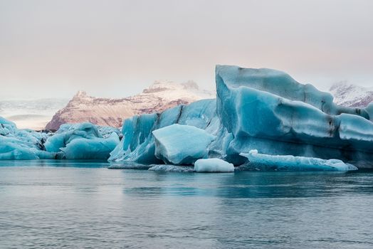 Icebergs in the Jokulsarlon's lake near Vatnajokull glacier at sunrise, Iceland