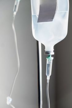 Close up of IV saline solution drip for patient in hospital