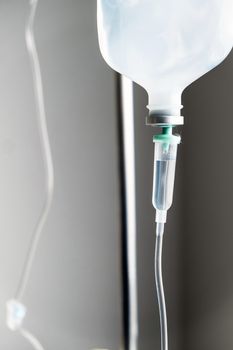 Close up of IV saline solution drip for patient in hospital