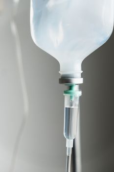 Close up of IV saline solution drip for patient in hospital