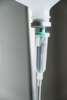 Close up of IV saline solution drip for patient in hospital