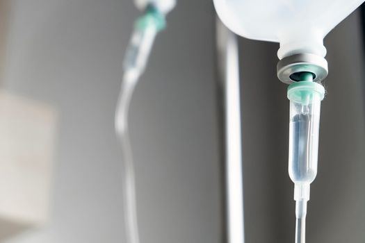 Close up of IV saline solution drip for patient in hospital