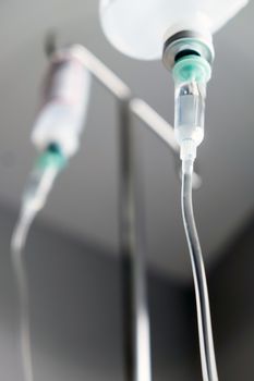 Close up of IV saline solution drip for patient in hospital