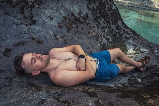 Man resting at river in Altai Mountains territory