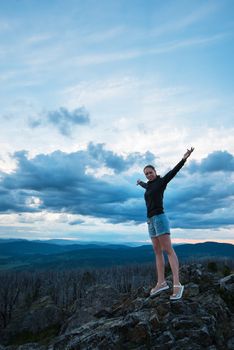 Travel, lesure and freedom concept - woman on the top of Altai mountain, beauty summer evening landcape