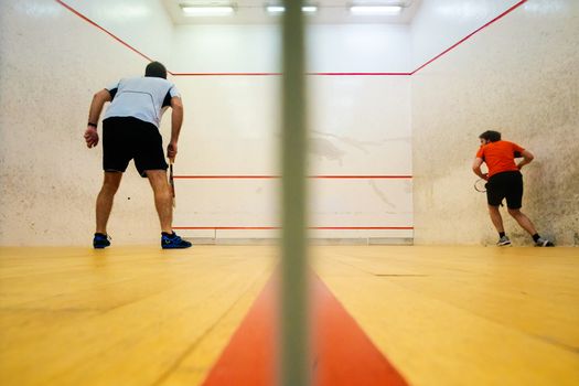 Two friends having good sport time playing squash in Mutilva, Navarra, Spain