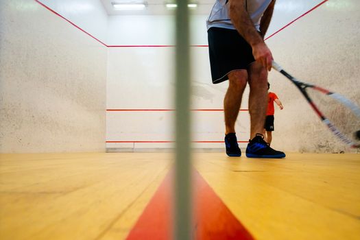 Two friends having good sport time playing squash in Mutilva, Navarra, Spain