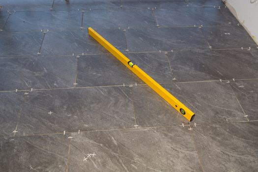 Balcony floor tiles installation. Laying tiles from porcelain. Interior remodeling theme.
