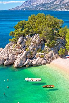 Idyllic emerald beach and boats in Brela aerial vertical view, Makarska riviera of Dalmatia, Croatia