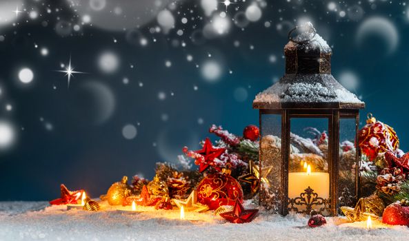 Burning candles , lantern and christmas decoration on magic bokeh lights background
