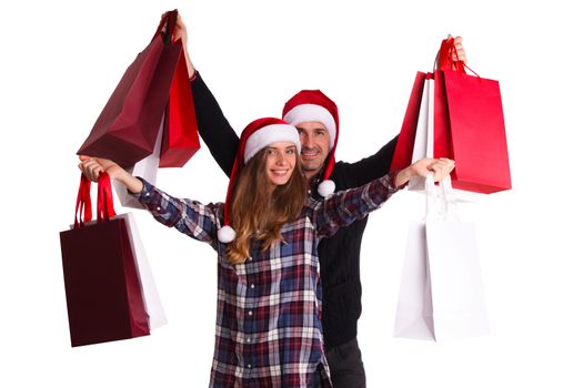 Happy beautiful couple holding many bags with christmas gifts isolated on white background