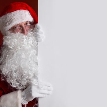 Santa Claus holding white paper billboard with copy space for text